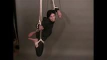 4 short videos in one of an beautiful black haired archive girl tied and gagged on the floor wearing sexy shiny nylon rainwear (Video)