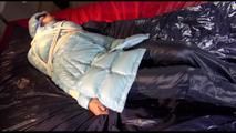 Lulu tied and gagged on a bed wearing a sexy blue shiny nylon rainpants and a iceblue PAMY downjacket (Video)
