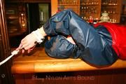 Jill tied and gagged in shiny rainwear