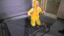 Ms Ungeniert tied and gagged in shiny nylon Rainwear trying to escape