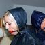 Katharina tied back to back to her friend in blue shorts and shiny blue cagoules