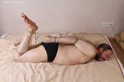 Amanda ties up and gags a man, then spanks and tickles him