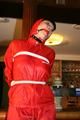 Jill bound in a red nylon rainsuit