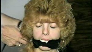 SEXY TERRI IS BALL-GAGGED, ACE BANDAGE GAGGED WHILE TIED TO CHAIR (D33-12)