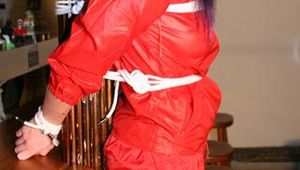 Jill bound in a red nylon rainsuit