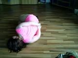 Sandra hogtied on the floor