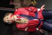 Sexy Sandra wearing sexy red/blue rainwear being tied and gagged with ropes and a clothgag on a chair (Pics)