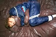 Stella tied and gagged in shiny nylon rainwear