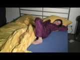 ENNI wearing a sexy purple shiny nylon rain suit lying in bed with yellow shiny nylon cloths lolling and posing (Video)