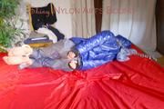 Sonja tied, gagged and hooded on bed with cuffs wearing a sexy grey shiny nylon rain pants and a blue down jacket (Pics)