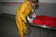 Watching Stella being tied and gagged with ropes and a ballgag on a operating table from Leonie both wearing sexy shiny nylon rainwear (Pics)