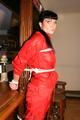 Jill bound in a red nylon rainsuit