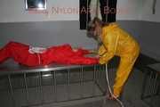Watching Stella being tied and gagged with ropes and a ballgag on a operating table from Leonie both wearing sexy shiny nylon rainwear (Pics)
