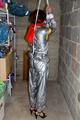 Nicole in an silver shiny PVC sauna suit tied and gagged in an cellar (Pics)