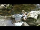 Sophie enjoying the water and weather on a river wearing supersexy grey sauna pvc rainwear (Video)