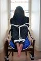 Stella tied and gagged on a chair wearing a blue shiny nylon shorts and a rain jacket (Pics)