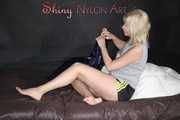 Watching Pia preparing her bed wearing a sexy black shiny nylon shorts and a grey tshirt (Pics)