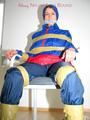 Katharina tied by using tape, gagged and hooded on a chair wearing sexy red/blue rainwear (Pics)