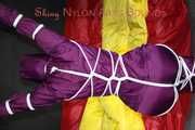 Watching sexy Sonja wearing a supersexy purple shiny nylon rainwear combination being tied and gagged overhead with ropes and a clothgag (Pics)