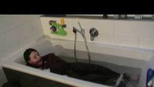 Watch Maggy beeing bound and gagged in a bathtube wearing a shiny nylon Skisuit from our Archives 2012