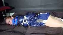 ***RONJA*** being tied and gagged on a sofa with ropes and a clothgag wearing a sexy blue shiny nylon shorts and a rainjacket (Video)