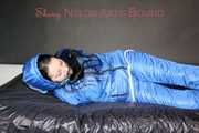 Lucy wearing sexy lightblue downwear tied and gagged with ropes and cloth gag on a bed (Pics)