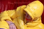 Sonja tied, gagged and hooded on a sofa wearing a sexy blue rain pants and a yellow downwear jacket (Pics)