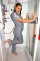 Stella wearing a supersexy grey rainwear catsuit under the shower (Pics)