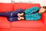 SEXY ALINA playing with cuffs wearing a hot blue shiny nylon down pants and a green down jacket lolling on the sofa (Pics)