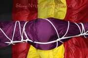 Watching sexy Sonja wearing a supersexy purple shiny nylon rainwear combination being tied and gagged overhead with ropes and a clothgag (Pics)