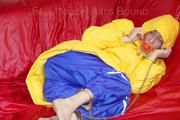 Sonja tied, gagged and hooded on a sofa wearing a sexy blue rain pants and a yellow downwear jacket (Pics)