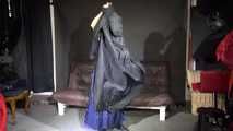 Watching sexy Sandra wearing a supersexy long rainwear skirt trying on several rain coats with hoods (Video)