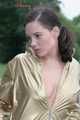 Watching out beautiful archive girl wearing a white shiny nylon shorts and a golden rain jacket posing outdoor (Pics)