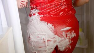 Lucy wearing a sexy red shiny nylon jumpsuit during her shower (Pics)