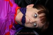Nicole bound and gagged in shiny pink nylon clothes