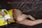 Sexy Lucy tied an gagged with ropes and a cloth gag wearing a super hot red shiny nylon shorts and a yellow rain jacket (Pics)