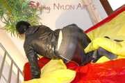 Lucy preparing her bed and enjoys it wearing sexy black rainwear (Pics)