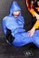 Jill bound and gagged by Simone in shiny nylon rainwear