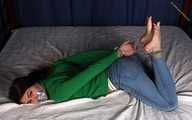 Roxana hogtied on bed