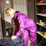 Sonja tidying up the shiny nylon clothes cupboard and folding the clothes wearing a supersexy purple rainwear suit (Pics) 