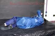 Lucy tied with cuffs overhead and gagged with a clothgag wearing sexy blue rain pants and a raincoat (Pics)