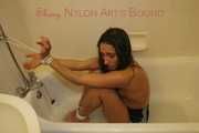 Stella tied and gagged with ropes and a cloth gag in a bath tub wearing ONLY a sexy black shiny nylon shorts (Pics)