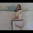 Jill enjoying herself on a sofa wearing white shiny nylon rain pants and a white down jacket (Video)