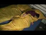 ENNI wearing a sexy purple shiny nylon rain suit lying in bed with yellow shiny nylon cloths lolling and posing (Video)