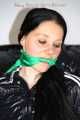 Lucy tied and gagged with rope and gag on a chair wearing a sexy black shiny nylon jumpsuit (Pics) 