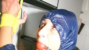 Stella tied, gagged and hooded in the kitchen wearing supersexy blue rainwear (Pics)