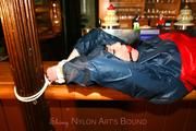Jill tied and gagged in shiny rainwear