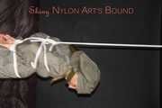 Sexy Sandra being tied and gagged overhead with ropes and a clothgag hodded wearing a sexy rainwear combination (Pics)