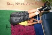 Stella tied and gagged on the floor wearing a shiny nylon rain pants (Pics)