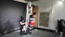 Marie taped and suspended in shiny nylon Rainwear